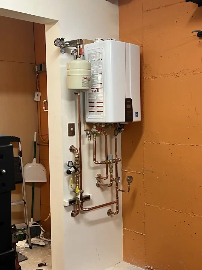 Plumbing technician inspecting water heater connections in Jersey City